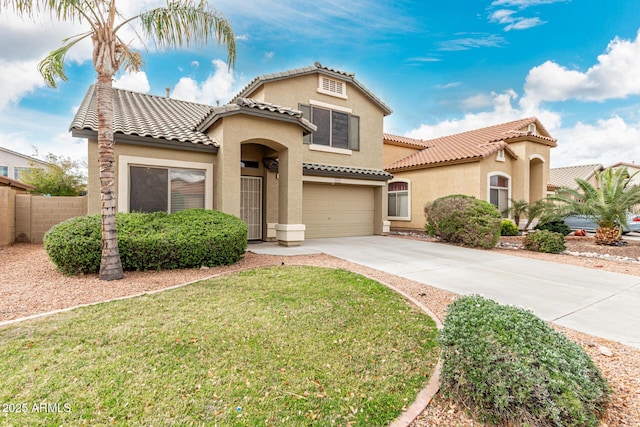 mediterranean / spanish-style home featuring stucco siding, a tiled roof, concrete driveway, and fence