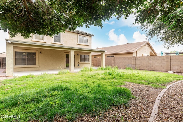 back of house featuring a patio area, fence, and stucco siding