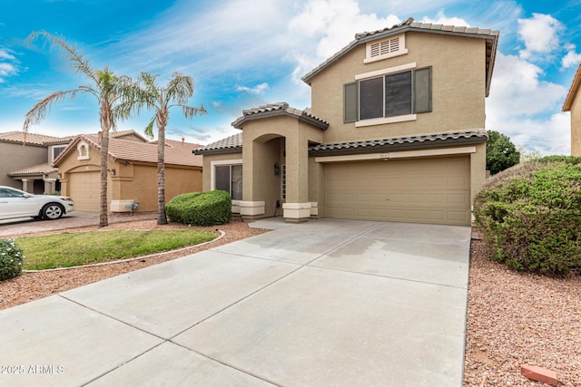 mediterranean / spanish home with stucco siding, a tiled roof, driveway, and a garage