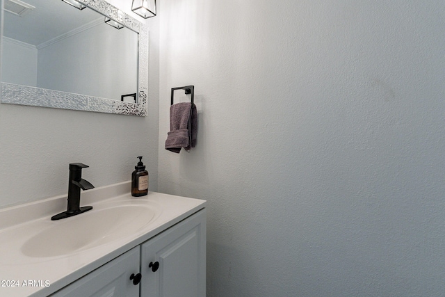 bathroom featuring ornamental molding and vanity