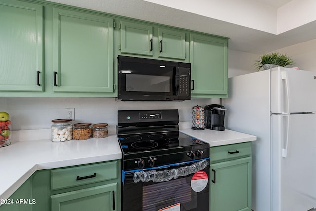 kitchen featuring black appliances and green cabinetry