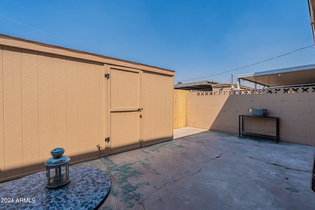 view of patio featuring a shed