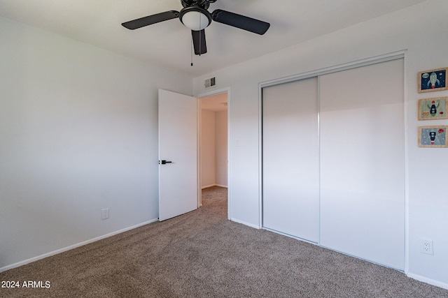 unfurnished bedroom featuring carpet, ceiling fan, and a closet