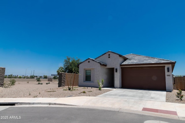 7933 N 79th Ave, Glendale, AZ 85303 - view of front of house with an attached garage, stucco siding, and driveway