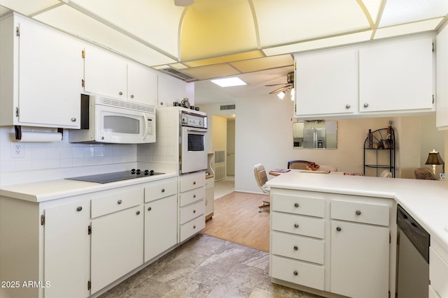 kitchen featuring tasteful backsplash, light countertops, visible vents, ceiling fan, and white appliances