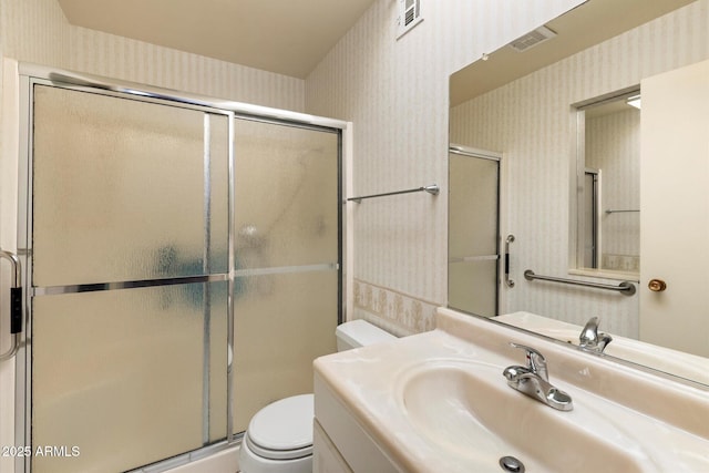 bathroom with toilet, wallpapered walls, visible vents, and a stall shower