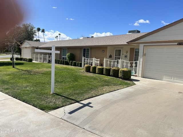 ranch-style home featuring a garage, concrete driveway, covered porch, and a front lawn