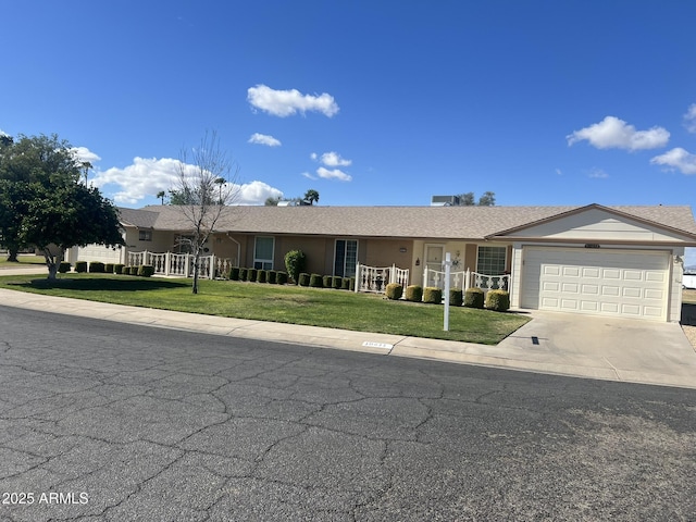 ranch-style house with an attached garage, covered porch, driveway, and a front lawn