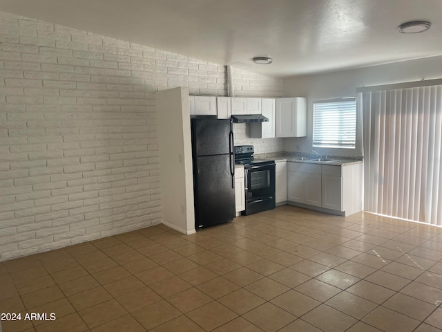 kitchen with brick wall, black appliances, sink, and white cabinets