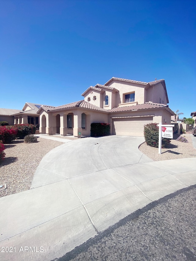 mediterranean / spanish house with a garage