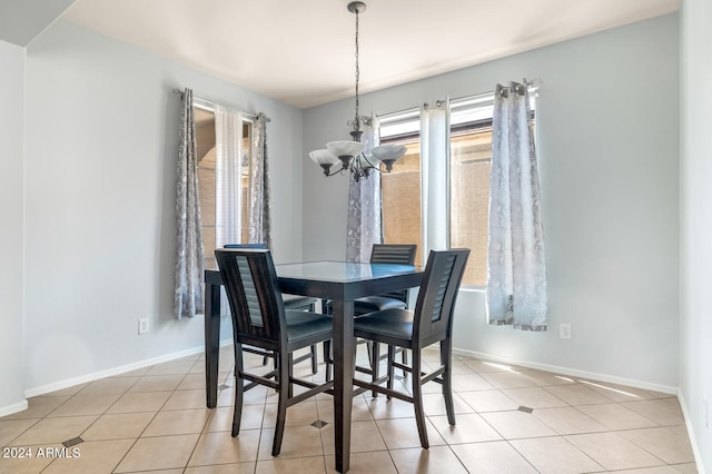 dining room with light tile patterned floors and an inviting chandelier