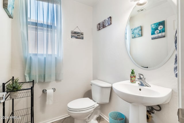 bathroom with tile patterned flooring and toilet