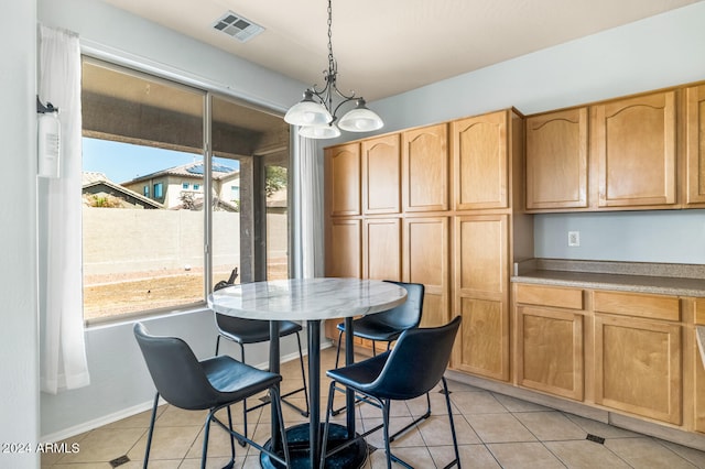 dining space featuring a chandelier and light tile patterned flooring