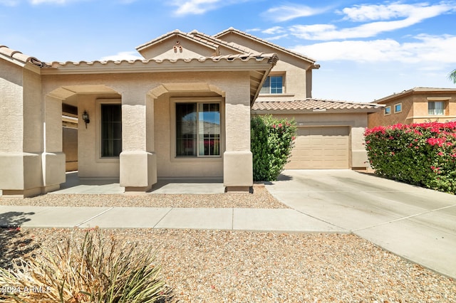 mediterranean / spanish-style home with a garage