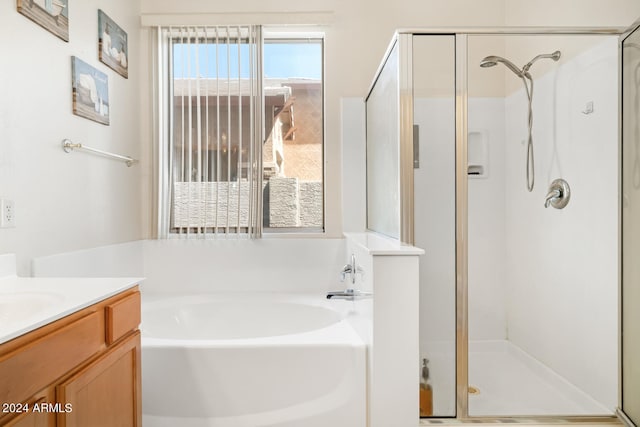 bathroom with vanity and independent shower and bath