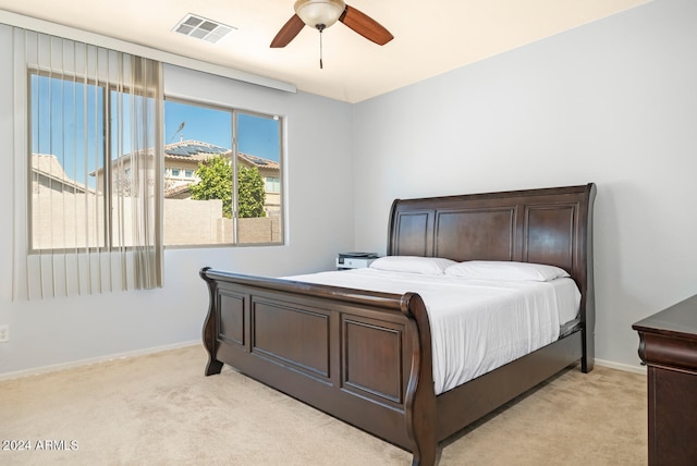 bedroom with ceiling fan and light colored carpet