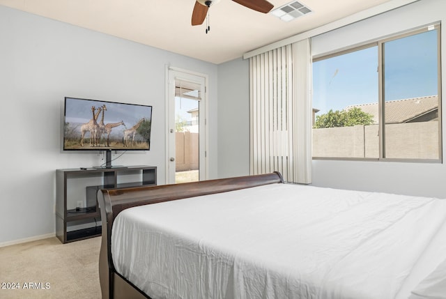 bedroom with ceiling fan and light carpet