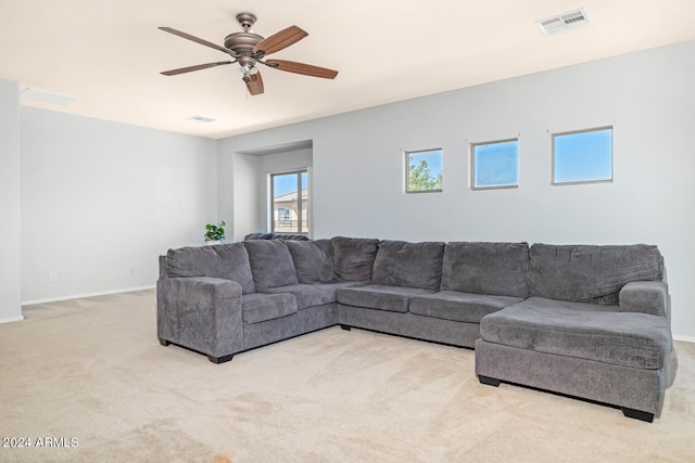 carpeted living room featuring ceiling fan