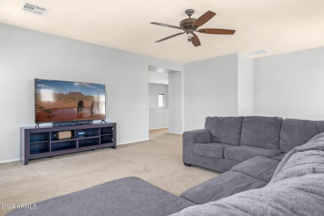 living room featuring light colored carpet and ceiling fan