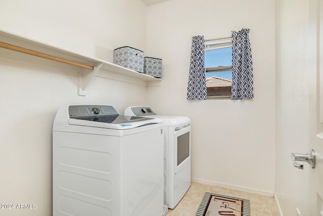 washroom with washing machine and dryer and light tile patterned floors