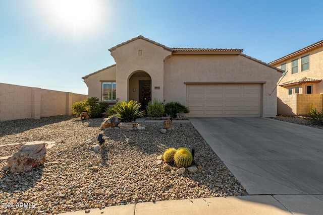 19104 N Smith Dr, Maricopa, AZ 85139 - mediterranean / spanish-style house featuring concrete driveway, stucco siding, an attached garage, a tile roof, and fence