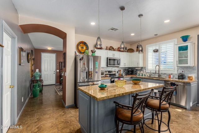 19104 N Smith Dr, Maricopa, AZ 85139 - kitchen featuring tasteful backsplash, arched walkways, visible vents, appliances with stainless steel finishes, and a sink