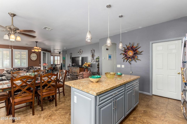 19104 N Smith Dr, Maricopa, AZ 85139 - kitchen with open floor plan, ceiling fan, gray cabinetry, and visible vents
