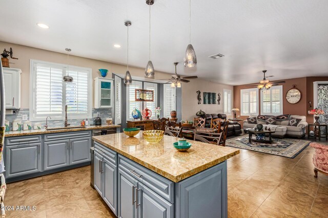 19104 N Smith Dr, Maricopa, AZ 85139 - kitchen with visible vents, a sink, a ceiling fan, gray cabinets, and a kitchen island