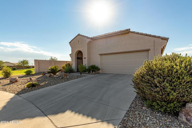 19104 N Smith Dr, Maricopa, AZ 85139 - mediterranean / spanish-style home with driveway, stucco siding, a tiled roof, and an attached garage