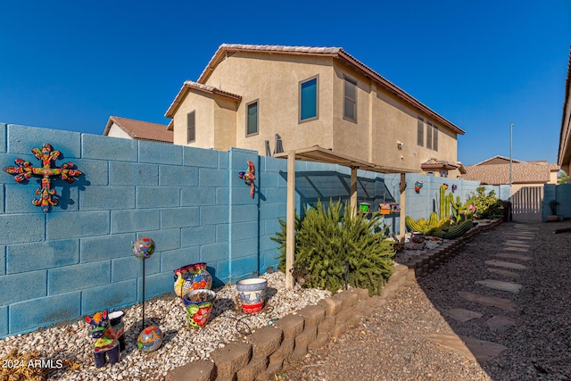 19104 N Smith Dr, Maricopa, AZ 85139 - view of home's exterior with fence, a gate, and stucco siding