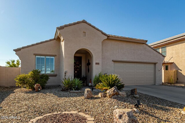 19104 N Smith Dr, Maricopa, AZ 85139 - mediterranean / spanish home featuring a garage, driveway, fence, and stucco siding