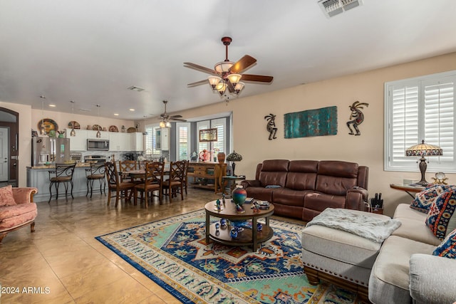 19104 N Smith Dr, Maricopa, AZ 85139 - living area with visible vents, a ceiling fan, plenty of natural light, and light tile patterned floors