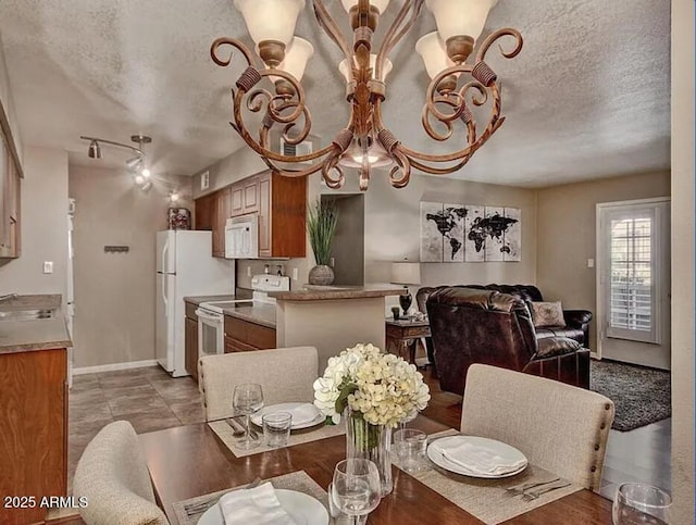 dining space with a textured ceiling and baseboards