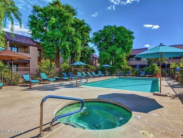 community pool featuring a hot tub, fence, and a patio