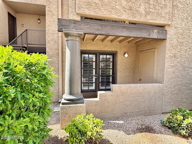 property entrance with stucco siding