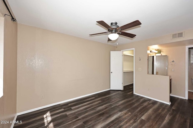 empty room featuring ceiling fan and dark hardwood / wood-style floors