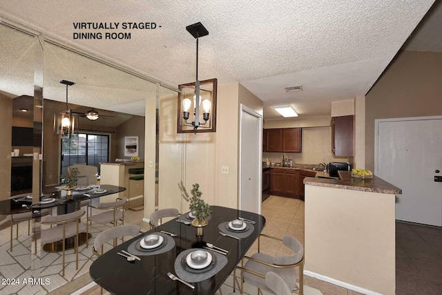 tiled dining area with lofted ceiling, sink, ceiling fan with notable chandelier, and a textured ceiling