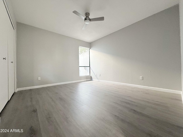 unfurnished room with wood-type flooring, ceiling fan, and lofted ceiling