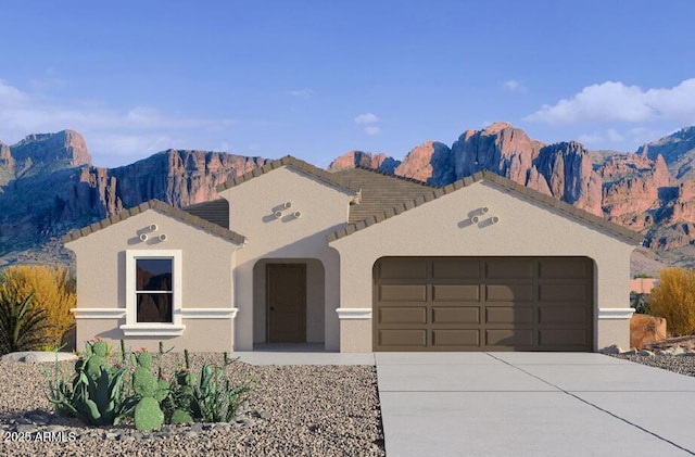 ranch-style home featuring a garage and a mountain view