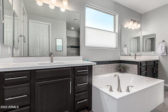 bathroom with vanity, a washtub, and hardwood / wood-style floors