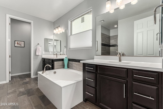 bathroom featuring vanity and shower with separate bathtub