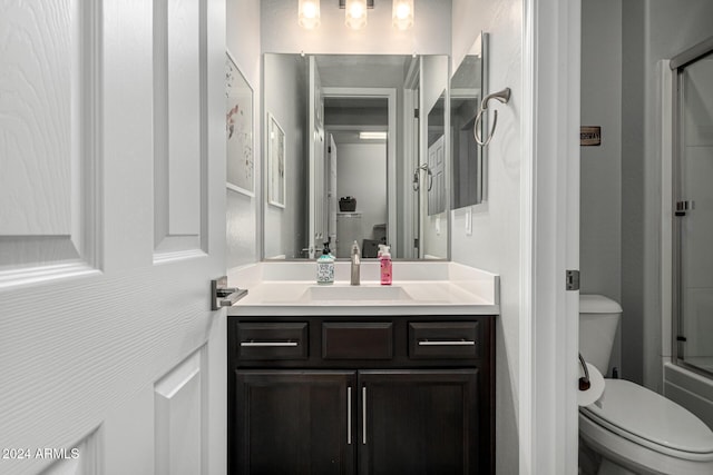 full bathroom featuring toilet, shower / bath combination with glass door, and vanity