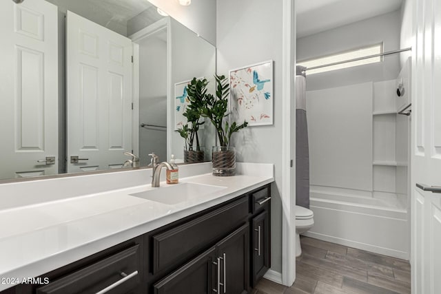 full bathroom featuring vanity, toilet, and washtub / shower combination