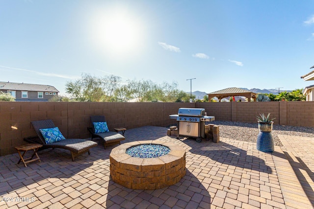 view of patio featuring an outdoor fire pit and grilling area