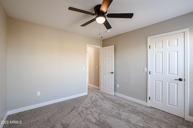 unfurnished bedroom featuring ceiling fan and light carpet