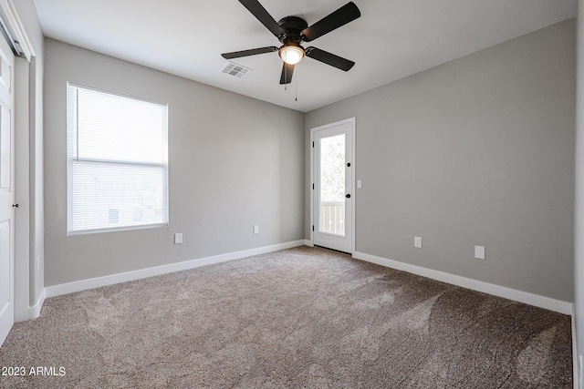 empty room with ceiling fan and carpet flooring