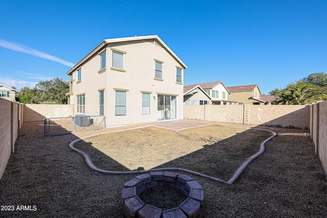 back of property with cooling unit, a patio, stucco siding, a residential view, and a fenced backyard