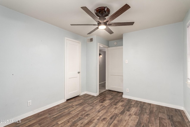 unfurnished bedroom with dark wood finished floors and baseboards