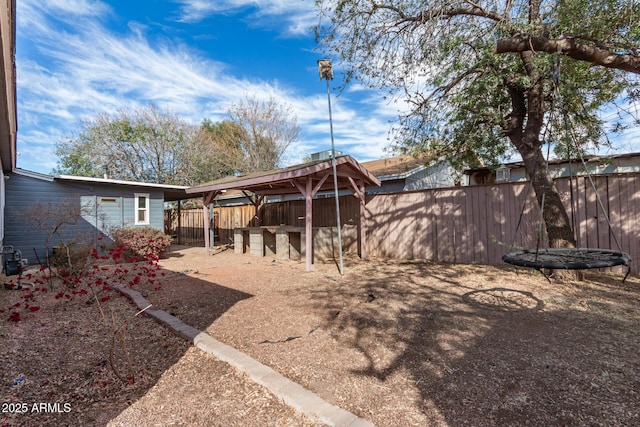 exterior space with a trampoline and a fenced backyard