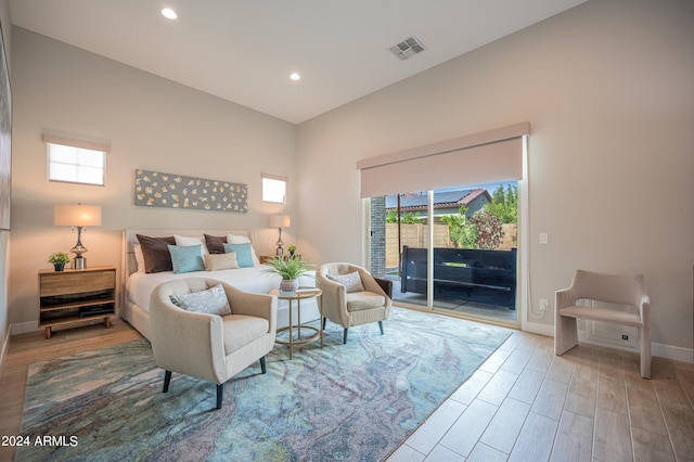 bedroom with access to exterior and wood-type flooring